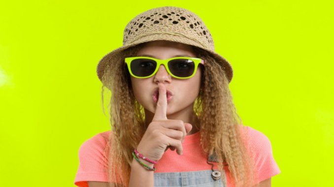 resize-1590568910752223058portraitteengirlsunglasseshatwithforefingernearlipsshowingsilencesign1164072719