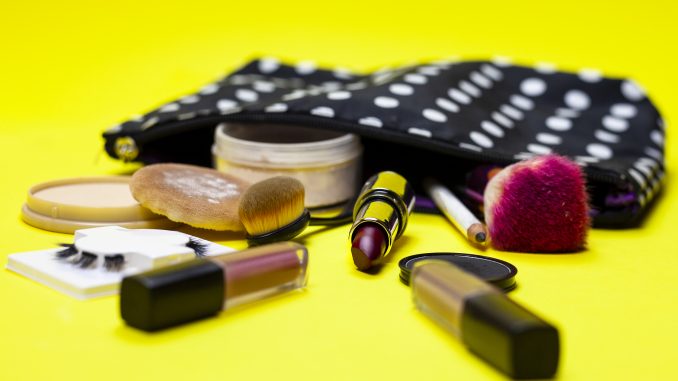 Cosmetics and Make Up Equipment on Yellow Background