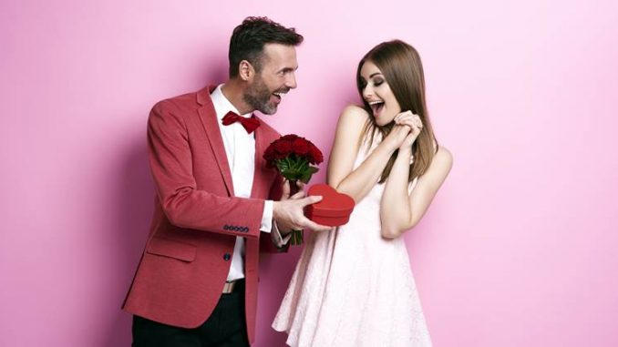 Man giving bunch of rose and chocolate box
