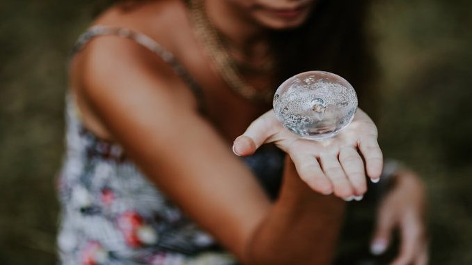 kaboompics_Woman-with-a-little-crystal-ball-1_680x380